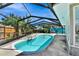 The backyard boasts a large, inviting pool surrounded by a screened enclosure, perfect for outdoor relaxation and entertainment at 4735 Baywood Point S Dr, Gulfport, FL 33711