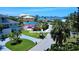 Street view showing lush landscaping and glimpses of the home on Baywood Point Drive at 4735 Baywood Point S Dr, Gulfport, FL 33711