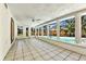 Bright sunroom with large windows overlooking the pool area, and tile floors at 4735 Baywood Point S Dr, Gulfport, FL 33711