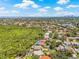 Stunning aerial view highlighting the property's location near lush greenery, a lake, and the ocean at 5270 White Sand Ne Cir, St Petersburg, FL 33703