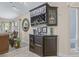 Dry bar area with custom cabinetry and wine storage in the living room at 5270 White Sand Ne Cir, St Petersburg, FL 33703