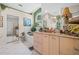 Well-lit bathroom with tiled floors, bathtub and plenty of counter space at 5270 White Sand Ne Cir, St Petersburg, FL 33703