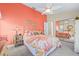 Bright bedroom with floral accents, mirrored closet, and ceiling fan at 5270 White Sand Ne Cir, St Petersburg, FL 33703