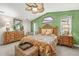 Vaulted ceiling bedroom with floral bedding, ceiling fan, and natural light from windows at 5270 White Sand Ne Cir, St Petersburg, FL 33703