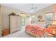 Bright bedroom featuring vibrant floral bedding and matching window valances plus a ceiling fan at 5270 White Sand Ne Cir, St Petersburg, FL 33703