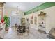Elegant dining area with decorative shelving, a modern chandelier, and large windows at 5270 White Sand Ne Cir, St Petersburg, FL 33703