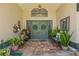 Inviting front entrance features double doors, decorative wreaths, and lush greenery at 5270 White Sand Ne Cir, St Petersburg, FL 33703
