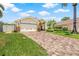 Charming single-story home with a well-maintained lawn, brick driveway, and a two-car garage at 5270 White Sand Ne Cir, St Petersburg, FL 33703