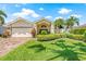 Beautiful home featuring well-manicured landscaping, palm trees, and a brick driveway at 5270 White Sand Ne Cir, St Petersburg, FL 33703