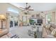 Spacious living room with a fireplace, plush seating, and an open layout to a screened-in patio at 5270 White Sand Ne Cir, St Petersburg, FL 33703