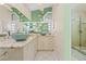 Bright main bathroom with dual sinks, granite countertops, and a walk-in shower at 5270 White Sand Ne Cir, St Petersburg, FL 33703