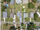 Overhead aerial perspective of a neat neighborhood, displaying orderly homes, manicured lawns, and street access at 6209 S Harold Ave, Tampa, FL 33616