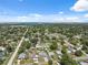 Wide aerial shot of a residential neighborhood with tree-lined streets and glimpses of a bay in the distance at 6209 S Harold Ave, Tampa, FL 33616