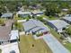Aerial view of a home with a red garage door, a well-manicured lawn, and a white privacy fence at 6209 S Harold Ave, Tampa, FL 33616