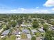 Expansive aerial view of a residential neighborhood, showcasing lush greenery and a mix of single-Gathering homes at 6209 S Harold Ave, Tampa, FL 33616