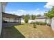 Large backyard with a screened-in porch and a shed, enclosed by a white privacy fence at 6209 S Harold Ave, Tampa, FL 33616