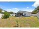 Backyard with a white privacy fence, featuring a patio cover attached to the house at 6209 S Harold Ave, Tampa, FL 33616