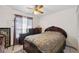 Cozy bedroom with a ceiling fan, a window with curtains, and dark wood furniture including a large bed at 6209 S Harold Ave, Tampa, FL 33616
