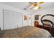 Cozy bedroom with a ceiling fan, a closet, and dark wood furniture including a dresser and mirror at 6209 S Harold Ave, Tampa, FL 33616