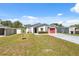 Inviting single-Gathering home boasting a well-kept lawn, colorful accents, and a convenient attached garage at 6209 S Harold Ave, Tampa, FL 33616
