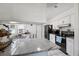 Bright kitchen featuring white cabinets, granite countertops, and stainless steel appliances at 6209 S Harold Ave, Tampa, FL 33616