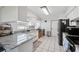 Bright kitchen featuring white cabinets, gray countertops, and stainless steel appliances at 6209 S Harold Ave, Tampa, FL 33616