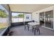 Enclosed porch with white plastic table and chairs, and a black frame enclosing screens at 6209 S Harold Ave, Tampa, FL 33616