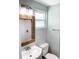 Stylish bathroom featuring a modern sink, woven mirror, and tile shower at 690 Fox St, Longboat Key, FL 34228