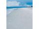 Expansive beach view with white sand and gentle waves, inviting for relaxation and coastal living at 690 Fox St, Longboat Key, FL 34228