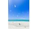 Bright beach view with clear blue sky, white sand, and peaceful ocean, perfect for a serene escape at 690 Fox St, Longboat Key, FL 34228
