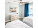 Bright bedroom with two twin beds, modern dresser and a ceiling fan for added comfort at 690 Fox St, Longboat Key, FL 34228