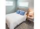 Cozy bedroom featuring a tufted headboard bed, soft blue pillows, and stylish décor at 690 Fox St, Longboat Key, FL 34228
