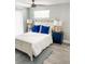 Inviting bedroom with blue accent pillows and contemporary bedside table lamps at 690 Fox St, Longboat Key, FL 34228