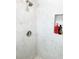 Tiled walk-in shower with built in toiletry shelf and stylish shower head at 690 Fox St, Longboat Key, FL 34228