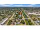 Aerial view shows the home's location, surrounded by mature trees and a canal to the east at 762 77Th N Ave, St Petersburg, FL 33702