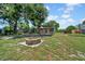 Back yard features a stone fire pit, mature trees and shady entertaining space at 762 77Th N Ave, St Petersburg, FL 33702