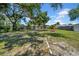 Spacious backyard features mature trees, fire pit, and covered seating area at 762 77Th N Ave, St Petersburg, FL 33702