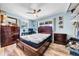Bright bedroom with wood floors, a ceiling fan, a window, and a desk area at 762 77Th N Ave, St Petersburg, FL 33702