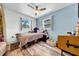 Cozy bedroom with a window, wood floors, a ceiling fan, and natural light at 762 77Th N Ave, St Petersburg, FL 33702
