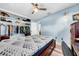 Bedroom with a closet, bed, and a desk, featuring wood floors and a ceiling fan at 762 77Th N Ave, St Petersburg, FL 33702