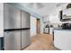 Bright kitchen featuring a large, modern stainless steel refrigerator and white cabinetry at 762 77Th N Ave, St Petersburg, FL 33702