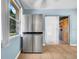 Kitchen featuring a stainless steel refrigerator, tile floors, and natural light from a window at 762 77Th N Ave, St Petersburg, FL 33702