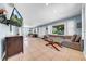 Open-concept living room featuring a large mirror wall and comfortable seating area at 762 77Th N Ave, St Petersburg, FL 33702