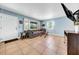 Bright living room with tile floors, a large window, and comfortable seating at 762 77Th N Ave, St Petersburg, FL 33702