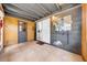 Covered porch area with tiled floor, sliding glass door and pegboard organizer at 762 77Th N Ave, St Petersburg, FL 33702