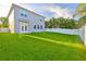 Spacious backyard features lush green grass and a privacy fence, perfect for outdoor activities at 7703 S West Shore Blvd, Tampa, FL 33616