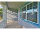 Inviting covered porch offers a tranquil outdoor space to relax and enjoy the neighborhood views at 7703 S West Shore Blvd, Tampa, FL 33616