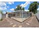 Backyard oasis featuring a screened pool and fenced-in yard at 8306 N Gomez Ave, Tampa, FL 33614