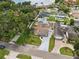 Aerial view of a home with a large pool, spacious yard and view of nearby lake at 8306 N Gomez Ave, Tampa, FL 33614