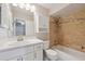 Well-lit bathroom features a tiled shower-tub combo and a white vanity at 8306 N Gomez Ave, Tampa, FL 33614